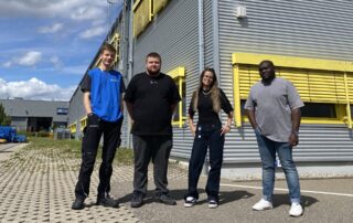 4 Personen vor dem Firmengebäude